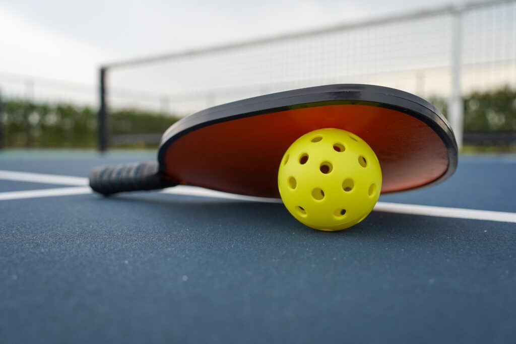 pickleballpaddlewithpickleballonpickleballcourt